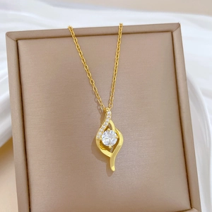Detail of gold-plated titanium steel necklace with micro-paved zircon pendant