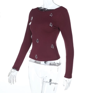 Detail of burgundy ribbed knit top featuring hanging crystal waterdrop embellishments