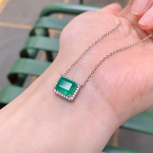 Detailed view of silver necklace with square green gemstone and micro-pave white zircons