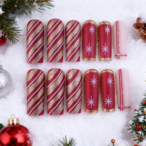 Christmas press-on nails with red snowflake patterns and glitter stripes in long coffin shape