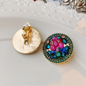 Vintage gold-plated round clip-on earrings featuring multi-colored crystals and rhinestones