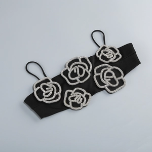 Detailed shot of silver rhinestone rose patterns on black strapless top fabric
