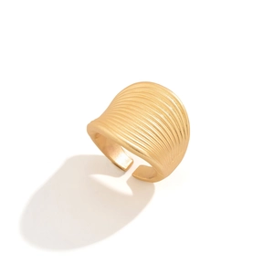 Detailed close-up of matte gold wide ring featuring horizontal brushed metal texture