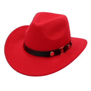 Close-up of red felt cowboy hat featuring black leather belt with gold metal buckles
