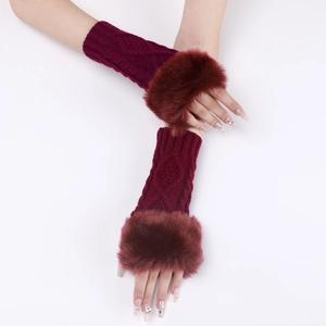 Close-up of wine red knitted fingerless gloves with soft faux fur trim for winter warmth