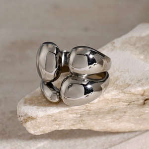 Macro shot of silver stainless steel double-layer ring with polished organic shapes