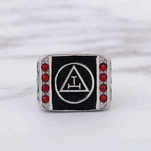 Macro view of Masonic Triple Tau ring featuring polished metal and eight red rhinestones