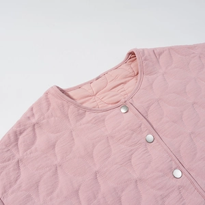 Close-up of pink quilted jacket featuring round neckline and silver metal press buttons