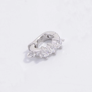Close-up of S925 sterling silver jewelry clasp with three small inlaid gemstones