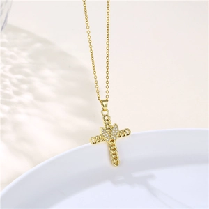 Dettaglio della collana a croce dorata con farfalla in zircone e strass scintillanti