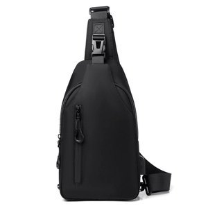 Close-up of black crossbody chest bag with built-in USB charging port for men