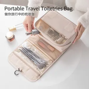Hanging travel toiletry bag in beige with multi-layer compartments and waterproof fabric