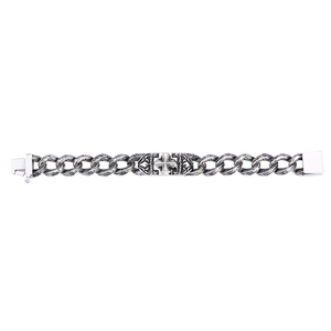 Detail of vintage punk silver cross bracelet with intricate floral engravings