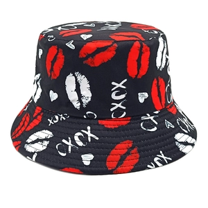 Black bucket hat featuring red lip prints and white graffiti art for sun protection
