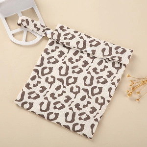 Stylish leopard print diaper bag with snap buttons and hanging strap for strollers