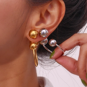 Chic 18K gold and silver U-shaped hoop earrings and studs set on model