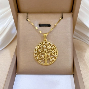 Detailed close-up of a golden Tree of Life pendant with zircon inlay on silk fabric