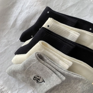Detail of breathable combed cotton socks with cute embroidery and polka dot patterns