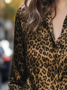 Detail of leopard print shirt featuring classic brown patterns and dark round buttons