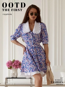 Detail of white oversized collar and floral print texture on purple summer dress