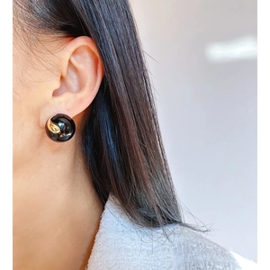 Chic handmade brown enamel round stud earring with gold spiral detail on model