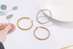 Detailed view of beaded hoop earrings in gold, silver, and rose gold finishes