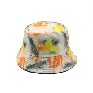 Close-up of tie-dye bucket hat showing reinforced stitching and vibrant orange-yellow patterns