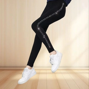 Women's black seamless thermal leggings with silver side sequins and elastic fit