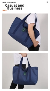 Detail of navy blue canvas travel tote showing durable handles and shoulder strap
