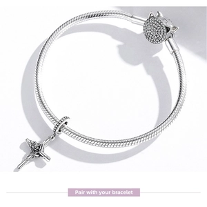 Detail of S925 sterling silver snake chain bracelet with rose cross and pave ball charm