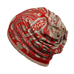 Close-up of red paisley pattern and soft cotton fabric on a pleated slouchy beanie