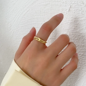 Minimalist irregular lava texture S925 sterling silver ring in gold on model's hand