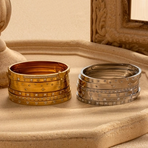 Stackable gold and silver stainless steel bangles with star and heart zircon charms