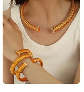 Detail view of gold textured collar and cuff set with sparkling rhinestone accents