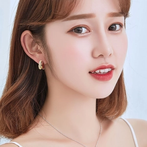 Vintage gold and brown enamel double C-hoop earrings with zircon inlay shown on model