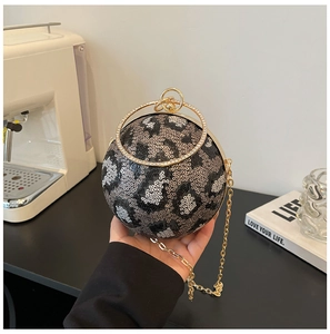 Close-up of leopard pattern sequins and sparkling rhinestone handle on a ball clutch bag