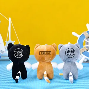 Macro view of three cute plush cat keychains from behind in different colors.