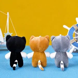 Macro view of three cute plush cat keychains from behind in different colors.