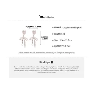 Detailed dimensions of bow pearl earrings measuring 2.5cm by 1.5cm with silver needle