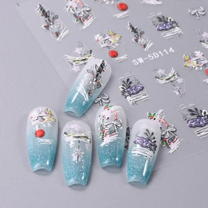 Detail of 5D embossed Christmas nail stickers with white bows and silver glitter accents