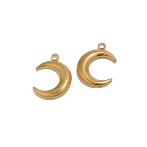 Detail of two gold polished crescent moon pendants for DIY jewelry necklaces