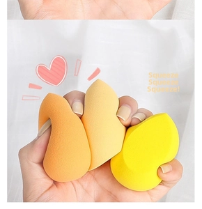 Close-up of soft beauty blenders being squeezed to show high elasticity and soft texture