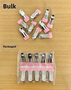 Detail of metal clothes pins with pink rubber tips in bulk and carded packaging options