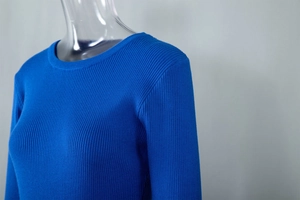 Detailed view of royal blue ribbed knit texture and round neckline on a fitted dress