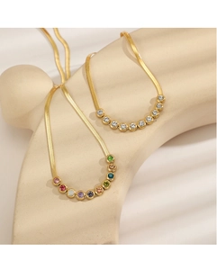 Detail of 18K gold snake chain necklace featuring colorful zircon gemstone pendant