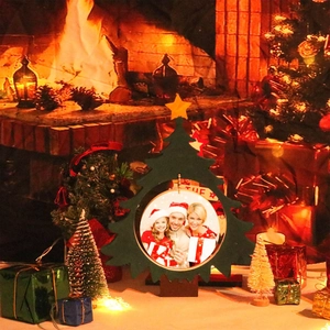 Green Christmas tree wooden photo frame with star topper in cozy festive setting