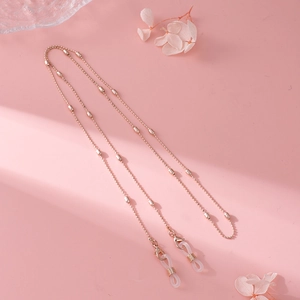 Detailed close-up of rose gold beaded eyewear chain with adjustable silicone loops