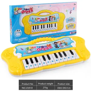Detailed view of yellow cartoon electronic keyboard toy with colorful packaging box