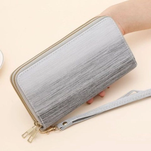 Close-up of grey gradient wallet with brushed texture and gold zipper hardware details