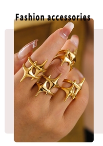 Detailed view of four 18k gold plated star rings worn on hand for a trendy layered look